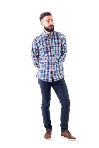 istock Cool relaxed flirty bearded man with hands behind back judging and looking away. 947279724