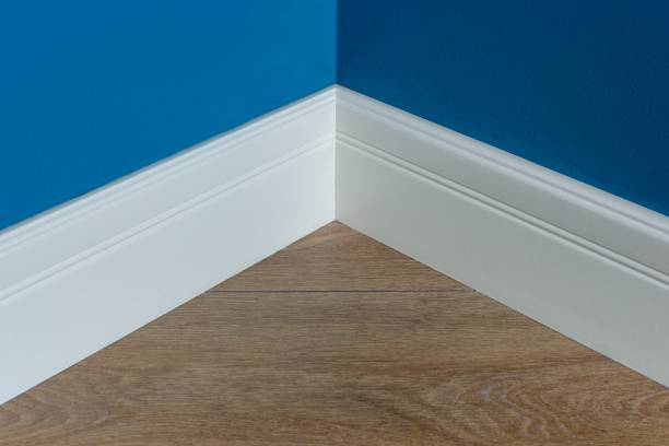 istock Moulding in the corner. Blue Matte Wall with laminate immitating oak texture 947282520
