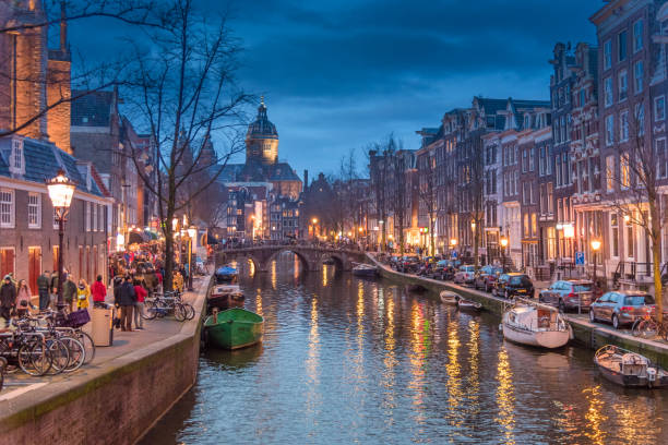 vista del quartiere a luci rosse e canale di amsterdam, biciclette e ciclisti, case galleggianti, barche viventi. signor presidente, signor presidente, signor presidente in una relazione - architettura ed edifici foto e immagini stock