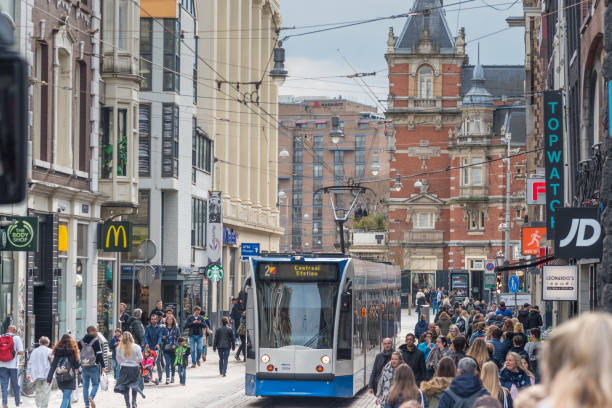 istock Trams and travellers in front of Amsterdam Central railway station 947286578