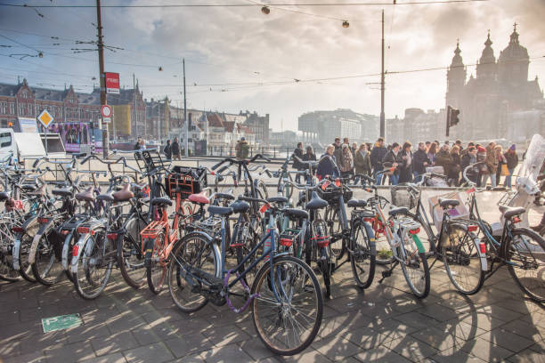 istock Trams and travellers in front of Amsterdam Central railway station 947290736