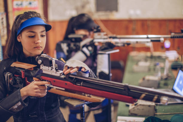 istock Girls on rifle shooting practice 947290924