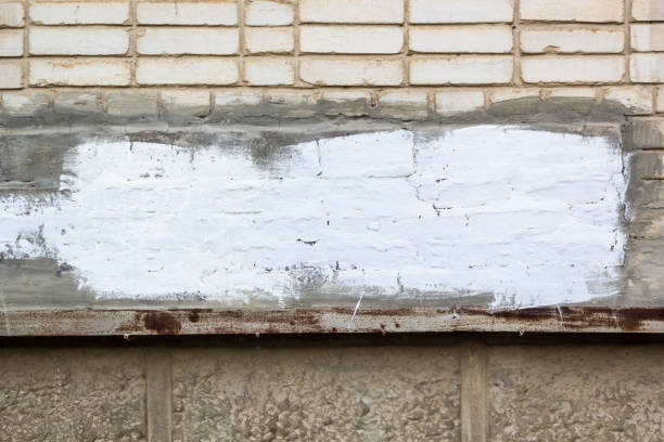istock brick wall with painted splotch for your text and paper scraps as background or texture 947291026