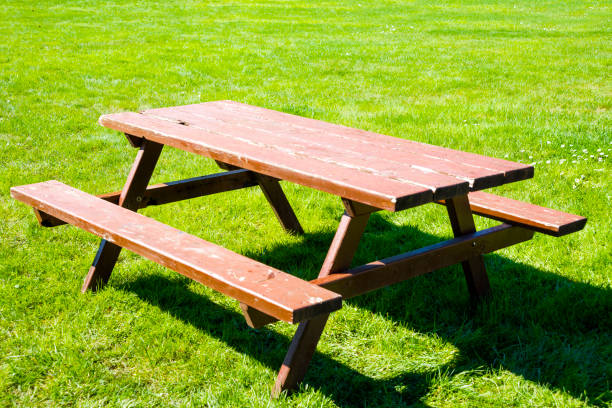 istock Wooden picnic table and bench in garden 947291588