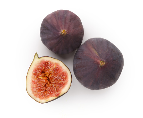 Sliced fresh figs on white background. Ripe sweet fresh organic fruit, top view