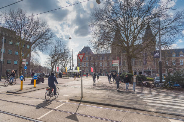 istock Trams and travellers in front of Amsterdam Central railway station 947292866