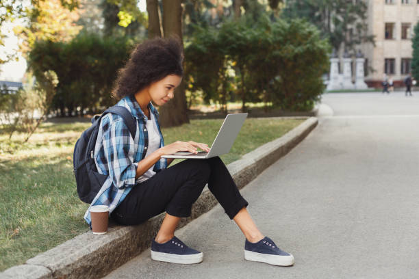 istock Young woman using laptop at university 947294494