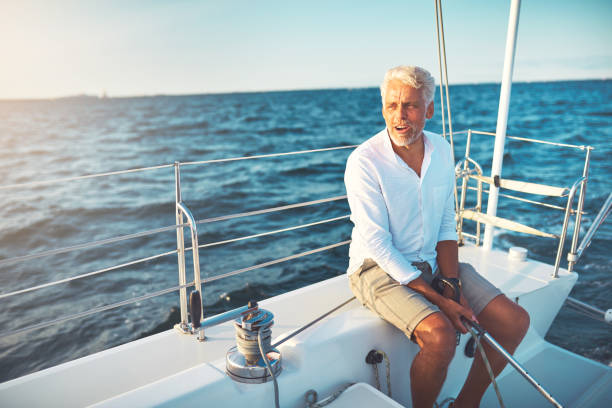istock Mature man sailing his boat on the open ocean 947295482