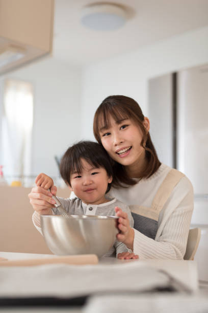 istock Mother and child making cookie together 947295676