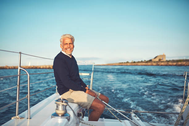 istock Mature man enjoying a day sailing on the ocean 947295970