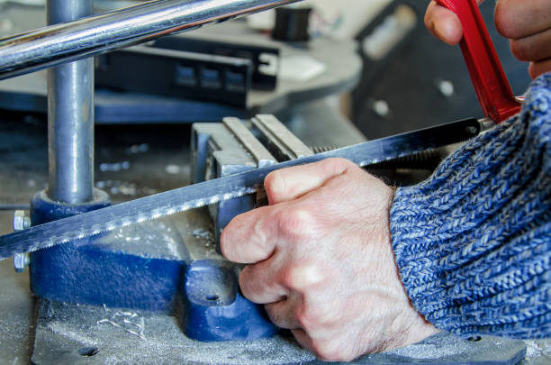 istock Man's hand is sawing a metal in a vice with a hacksaw 947298768