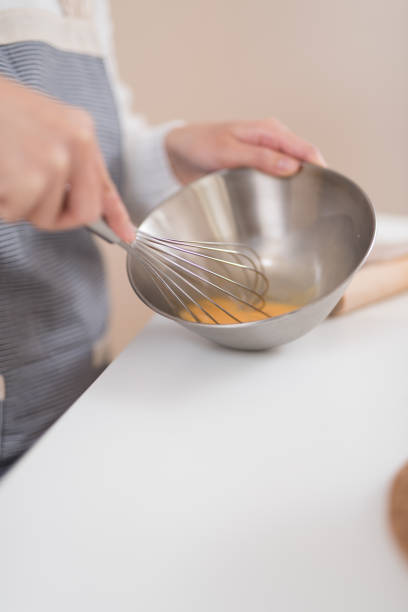 istock Woman mixing egg in bowl to make pastry 947299496