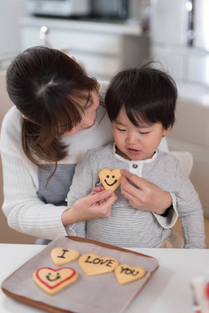 istock Mother and child making cookie together in kitchen 947300128