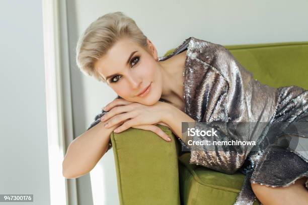 Beautiful Blonde Woman With Short Hair Sitting On Green Sofa Perfect Female  Face Stock Photo - Download Image Now - iStock