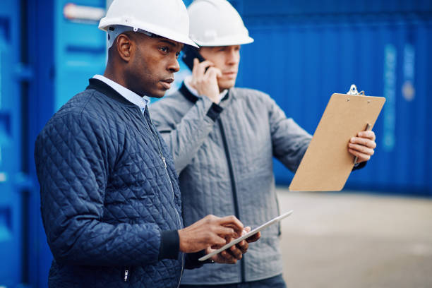 istock Engineers working together in a large commercial shipyard 947300348