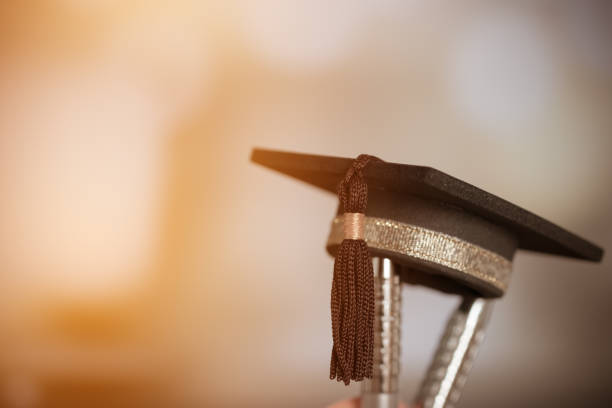 istock Graduate study abroad international school concept : Black graduation cap on silver pen in bottle. Education is knowledge and power for learning and success in your life, vintage tone 947304196