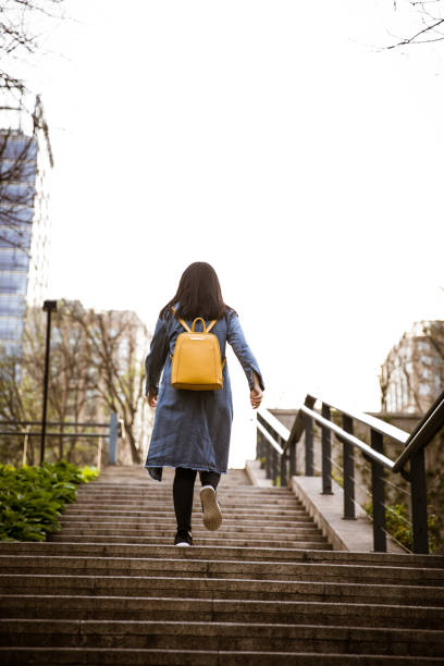 istock Young girl walking on stairs,Moving Up 947308900
