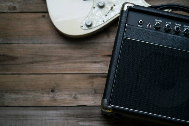 istock Guitar amplifier and a electric guitar on wood table 947314764