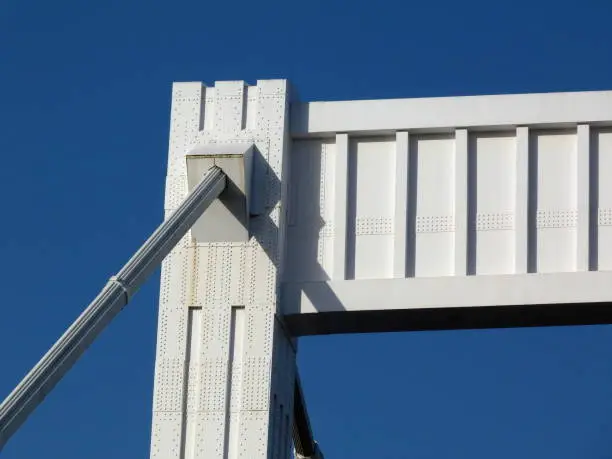 top portion of the Elisabeth Bridge in Budapest, Hungary. white with blue sky background in early morning light