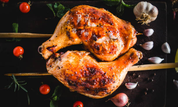 istock Chicken Hips Garlic pepper grilled Placed on a black wood chopping board 947316080