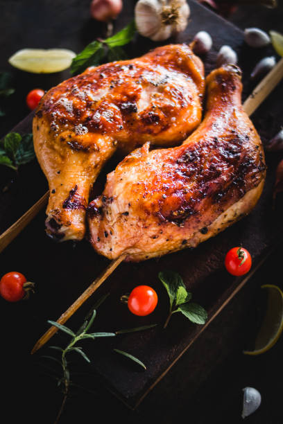 istock Chicken Hips Garlic pepper grilled Placed on a black wood chopping board 947316128