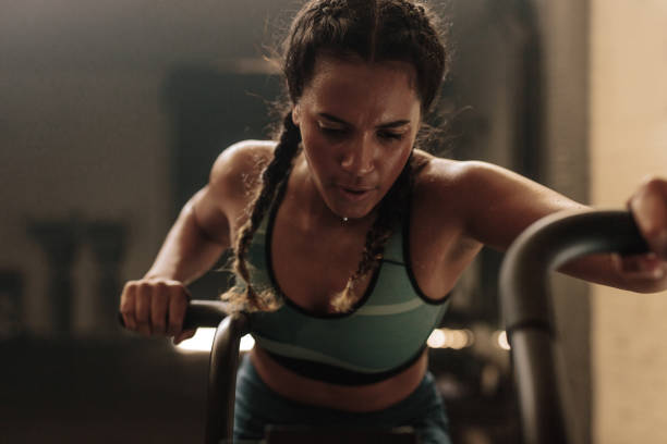 istock Woman doing intense workout on gym bike 947316584
