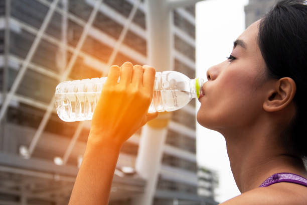 istock Women drinking water after sport exercise. 947316694