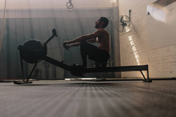 Fit man doing cardio workout in gym