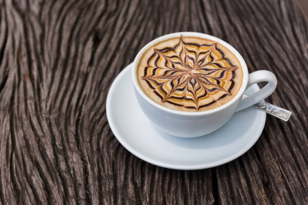 istock Latte art coffee cup  on texture wooden table 947319088