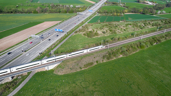 Railway bridge and train over highway - aerial view