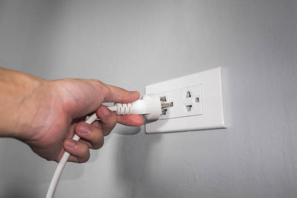 istock Hand putting the electric plug into the socket 947320380