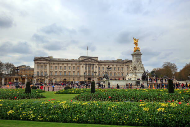 Buckingham Palace in London is the official residence of HM The Queen, and is open to the public in the summer months, surrounded by spring colourful flowers stock photo