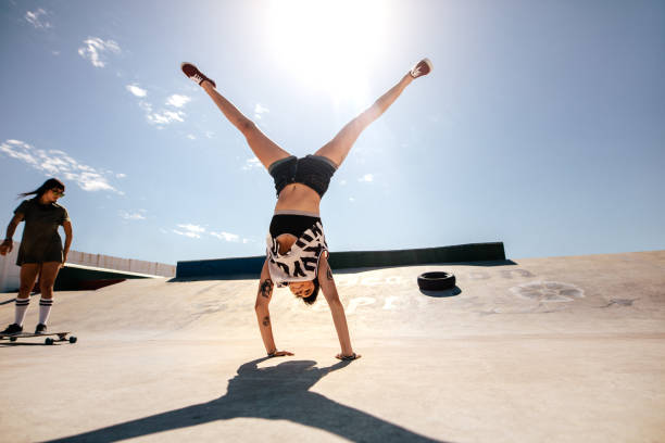 istock Girls doings stunts at skate park 947323662