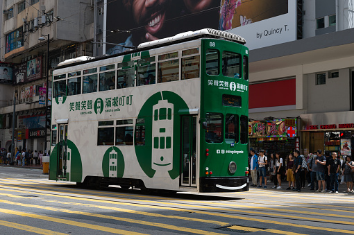 Central, Hong Kong - CIRCA April,2018:  Double deck tram on busy street of Central Hong Kong. Trams is major tourist attraction and famous transportation system in HK