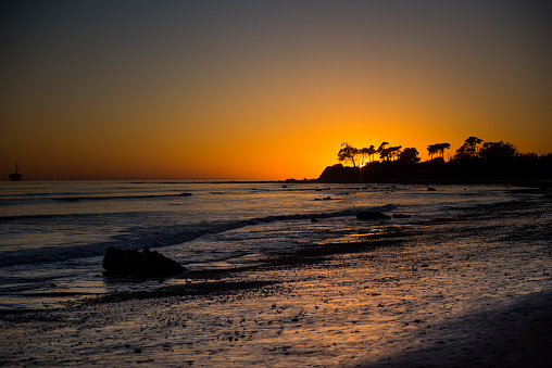 Family enjoying a beautiful sunset in the tide pools of Santa Barbara, father and son spend quality time together.