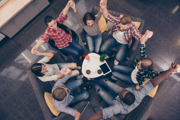 istock Partnership and teambuilding. Group of business people with raised hands 947324406