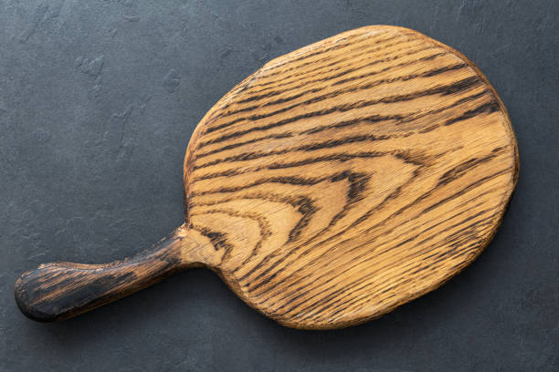 istock Wooden cutting board on slate background, top view with copy space for text 947326518
