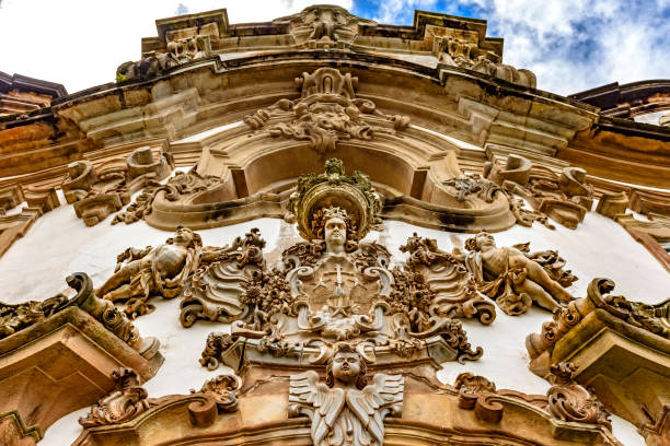 Baroque style sculptures and ornaments on the front facade of a old and historic church in the city of Ouro Preto in Minas Geraisil