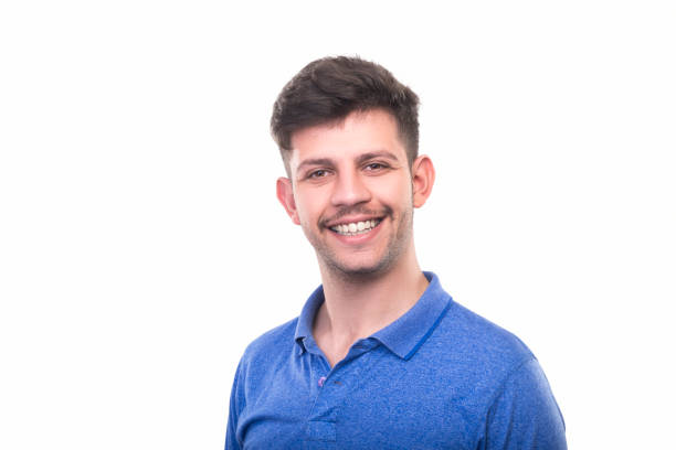 istock Portrait of laughing young man looking at camera on white background 947326768