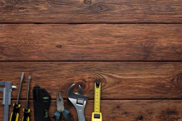istock Different tools and tape-measure on wood background 947326774