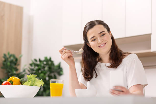 istock Glad jolly woman enjoying breakfast 947327566