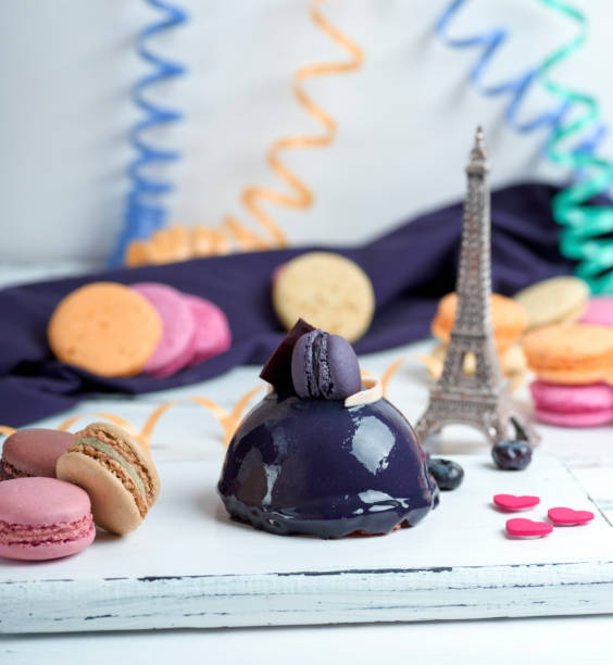 istock lilac round cake with macarons on a white wooden board, 947329602