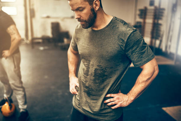 Fit young man sweating after a gym workout session stock photo