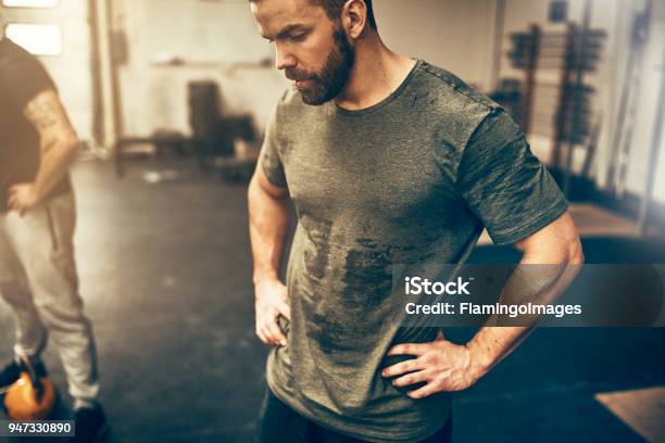 Fit Young Man Sweating After A Gym Workout Session Stock Photo - Download Image Now - Exercising, Sweat, Men