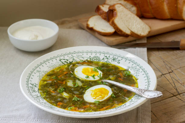 istock Vegetarian sorrel soup with egg, served with sour cream and bread. Rustic style. 947331664