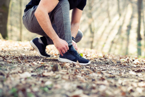 istock Runner tying his shoes preparing for a jog 947331698