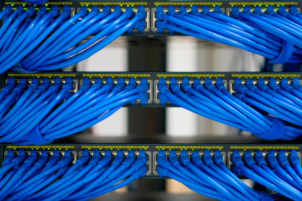 LAN cable wiring and networking in the network or server rack in the data center. stock photo