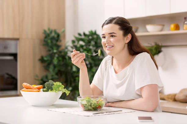 istock Happy cheerful woman tasting salad 947335026