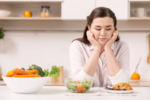 istock Pensive reflective woman choosing food 947335158