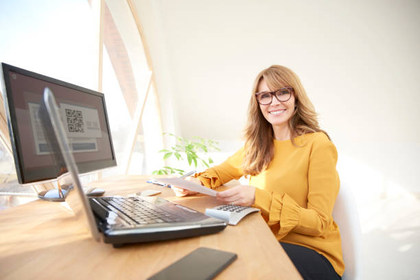 istock Smiling businesswoman working from home 947335646